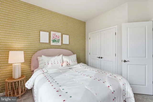 a bedroom with a bed and a night stand