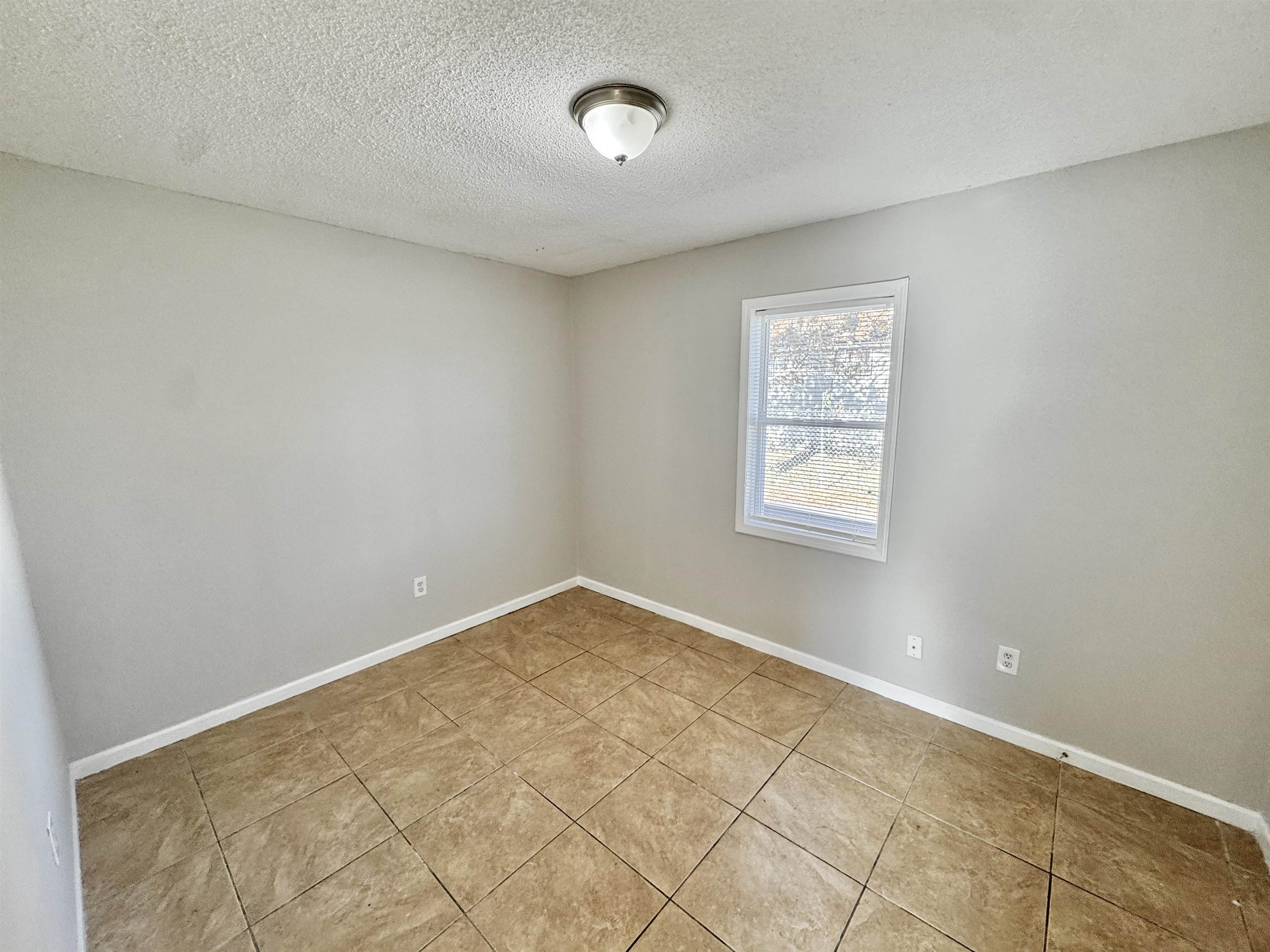 1825 Castalia Street Memphis, TN 38114 - Photo 11 of 30 an empty room with a window