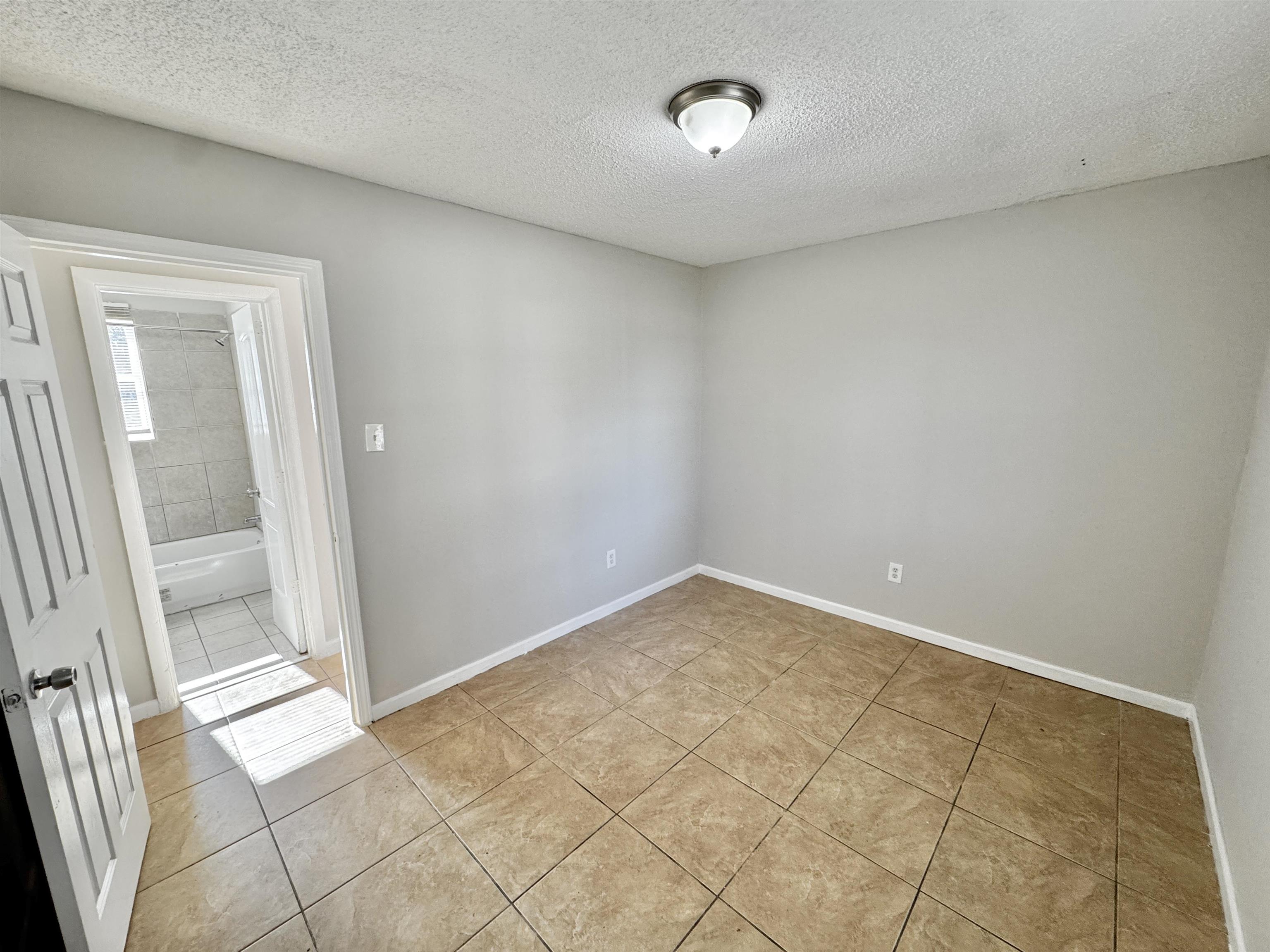 1825 Castalia Street Memphis, TN 38114 - Photo 12 of 30 an empty room with windows