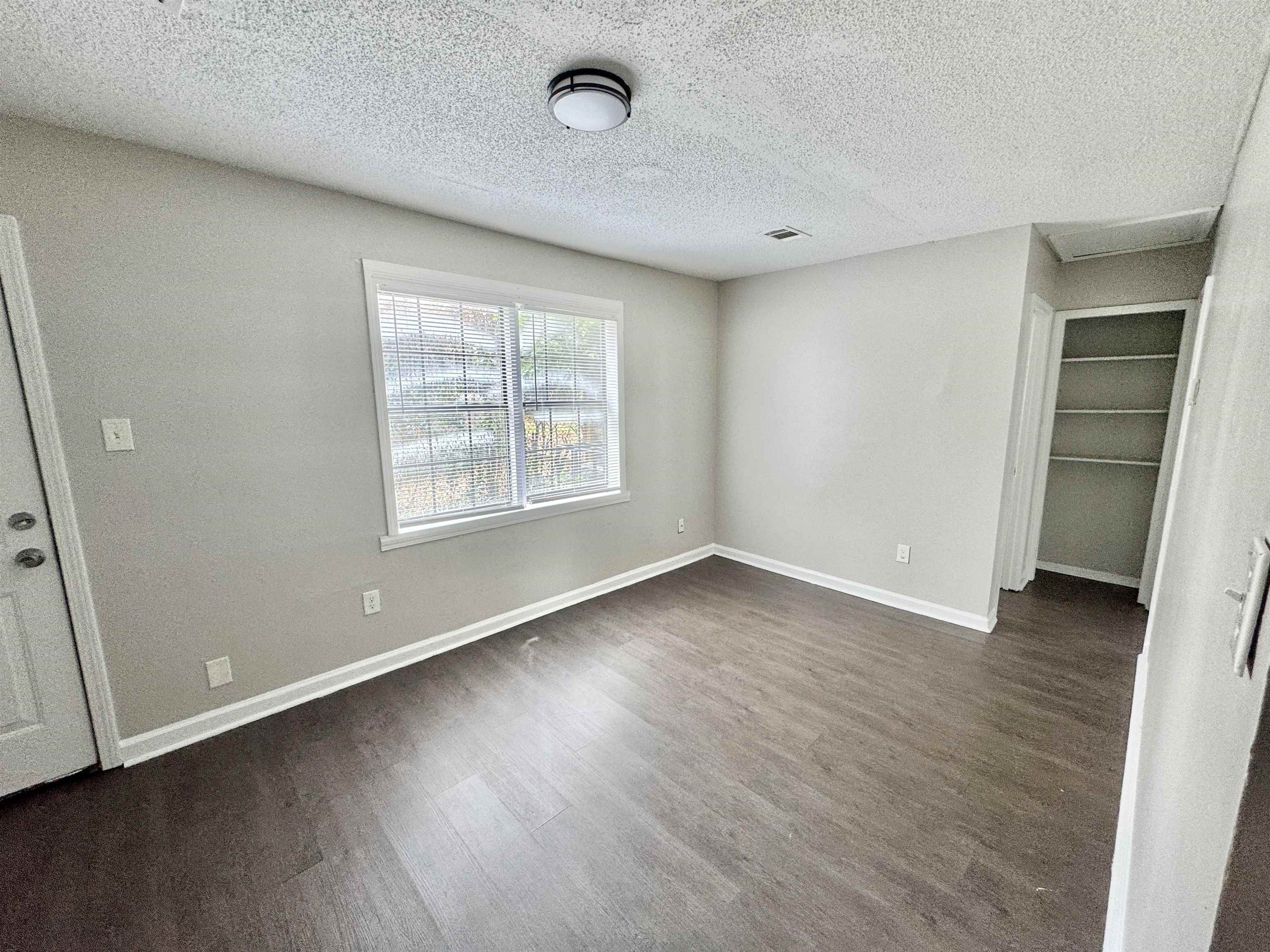 1825 Castalia Street Memphis, TN 38114 - Photo 13 of 30 an empty room with wooden floor and windows
