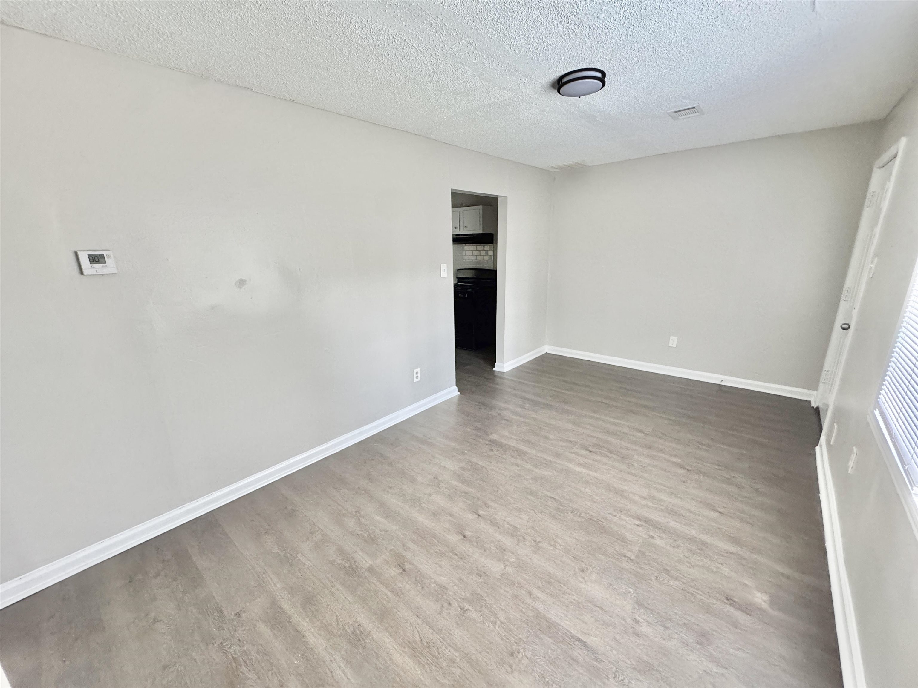 1825 Castalia Street Memphis, TN 38114 - Photo 14 of 30 a view of an empty room with wooden floor and closet