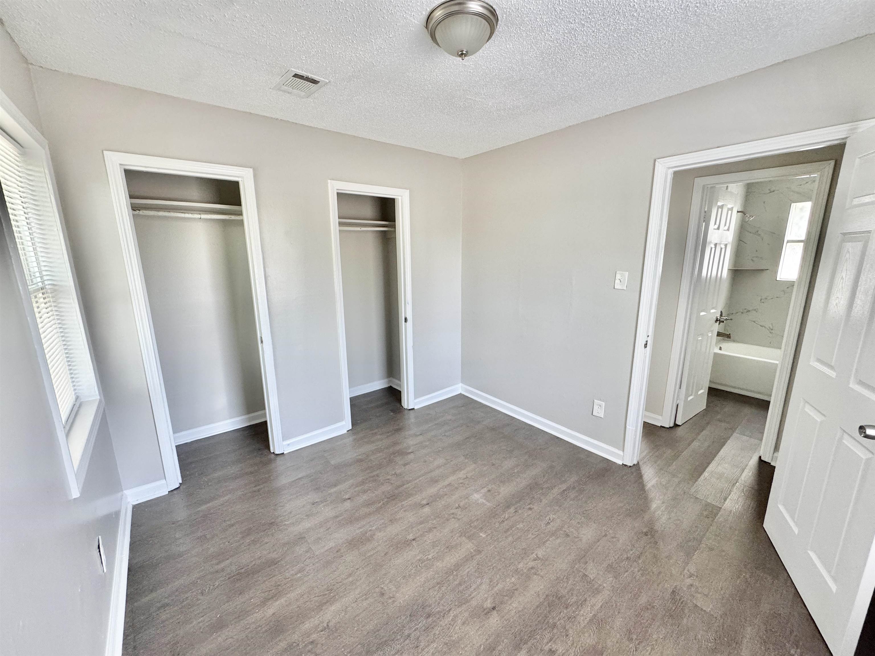 1825 Castalia Street Memphis, TN 38114 - Photo 15 of 30 an empty room with wooden floor and a window