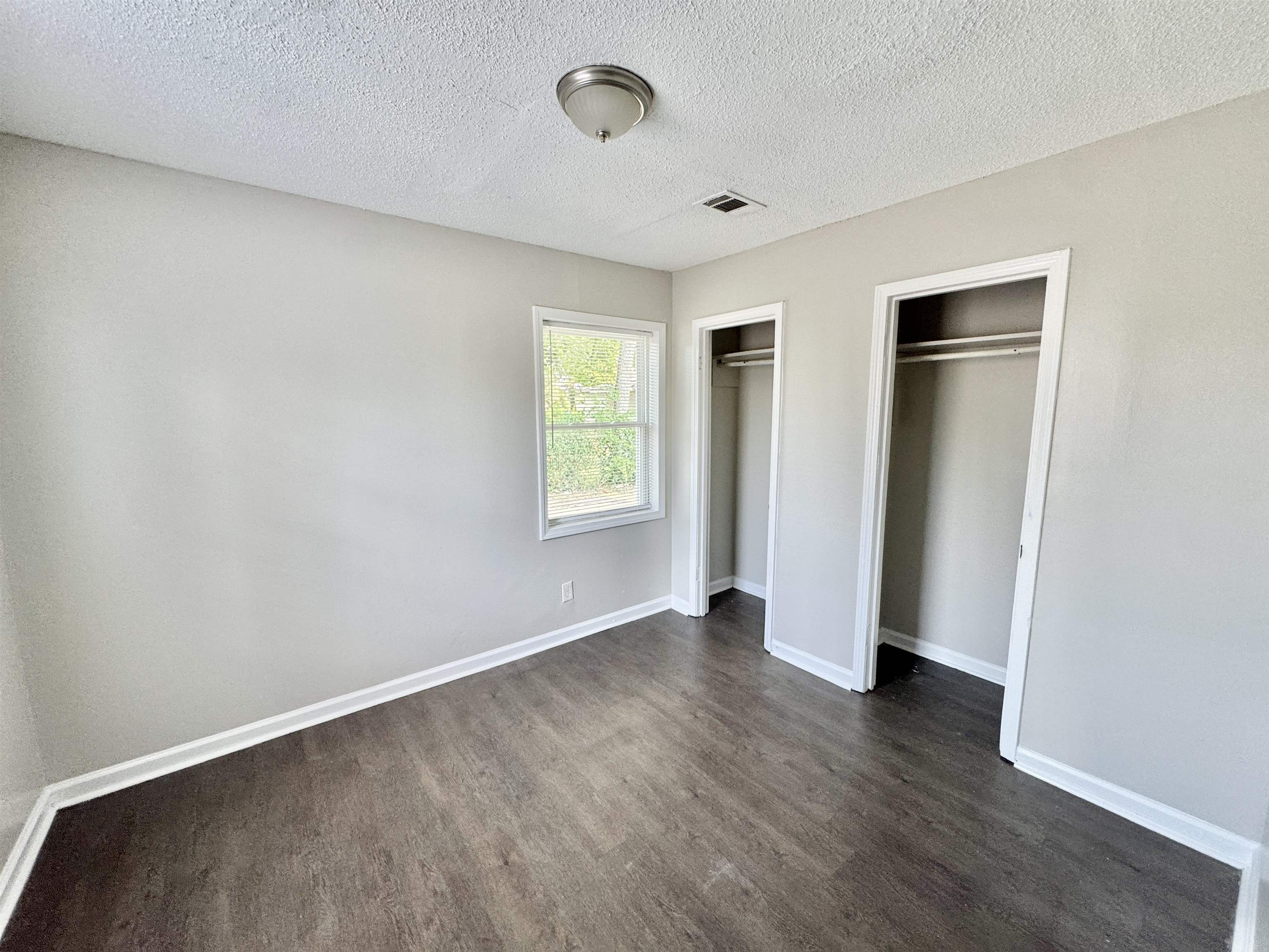 1825 Castalia Street Memphis, TN 38114 - Photo 18 of 30 an empty room with wooden floor and windows