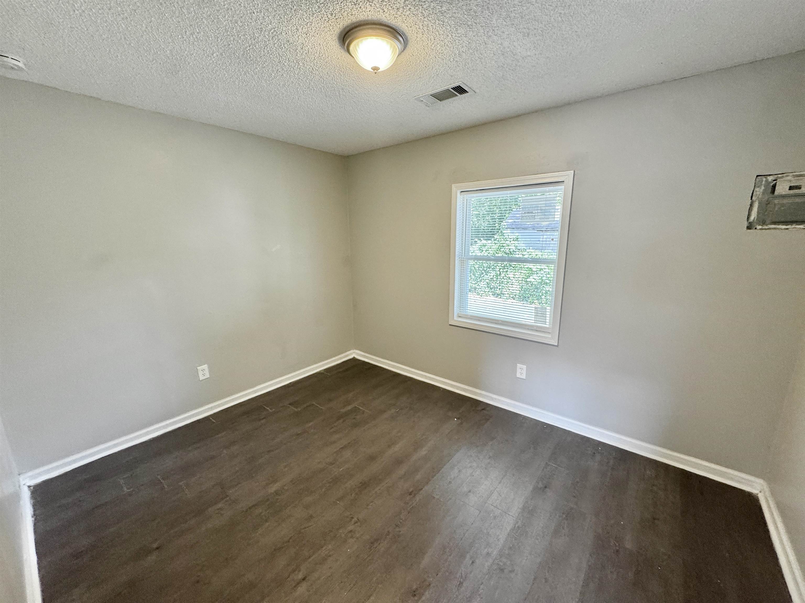 1825 Castalia Street Memphis, TN 38114 - Photo 27 of 30 an empty room with wooden floor and windows