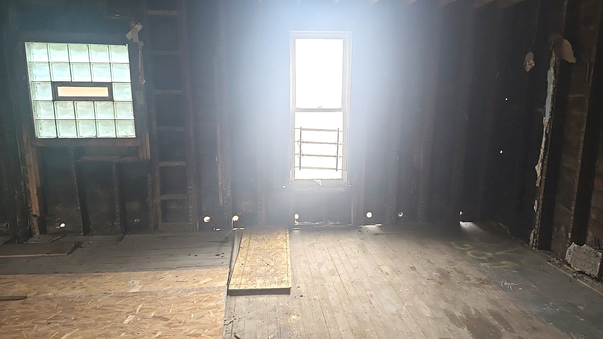738 West 103rd Street Chicago, IL 60628 - Photo 13 of 20 a view of an empty room with wooden floor and a window