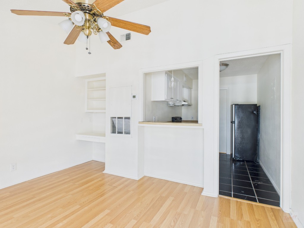 3000 Guadalupe Street, Unit 314 Austin, TX 78705 - Photo 2 of 12 a view of kitchen and empty room with wooden floor