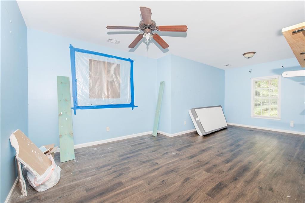 561 Holland Road Dallas, GA 30157 - Photo 33 of 48 a view of an empty room with a window and wooden floor