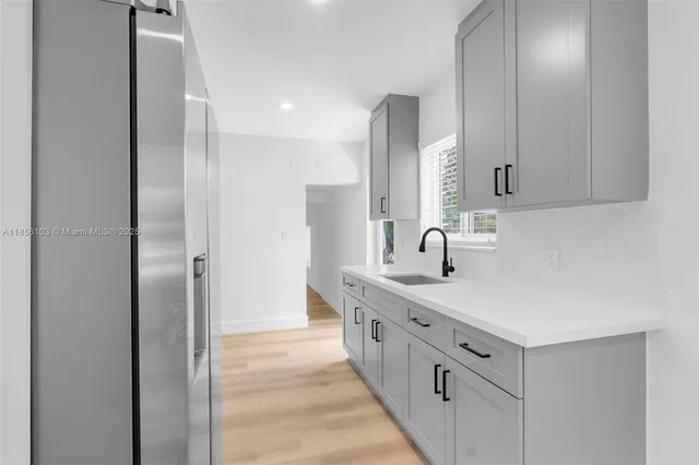 a spacious bathroom with a double vanity sink and mirror