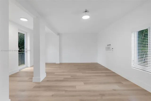 a view of wooden floor and windows in a room