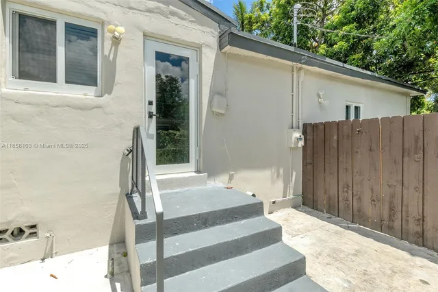 a view of a house with a backyard and tub