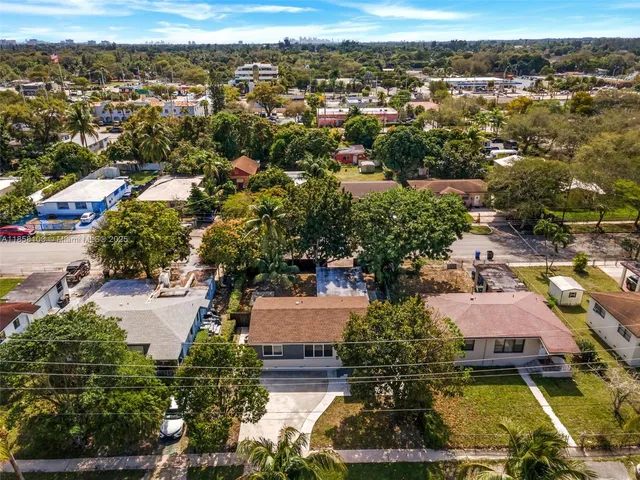 an aerial view of residential houses with outdoor space