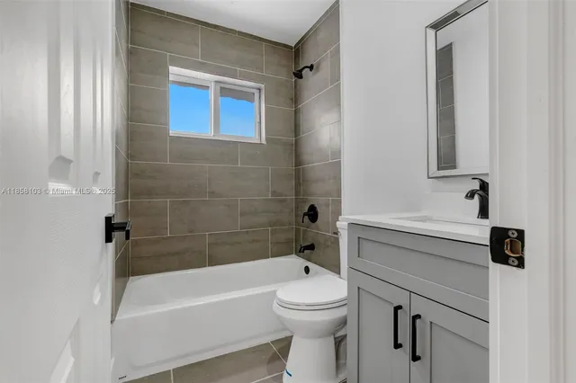 a bathroom with a sink a toilet and bathtub