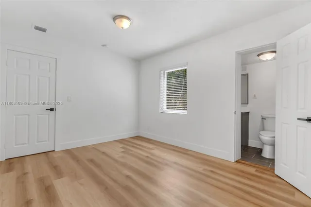 an empty room with a bathroom and a sink