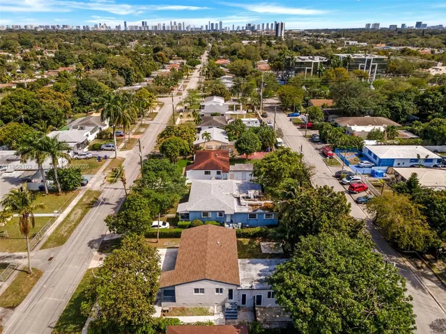 an aerial view of residential houses with outdoor space