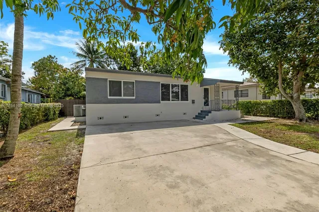 a backyard of a house with plants and trees