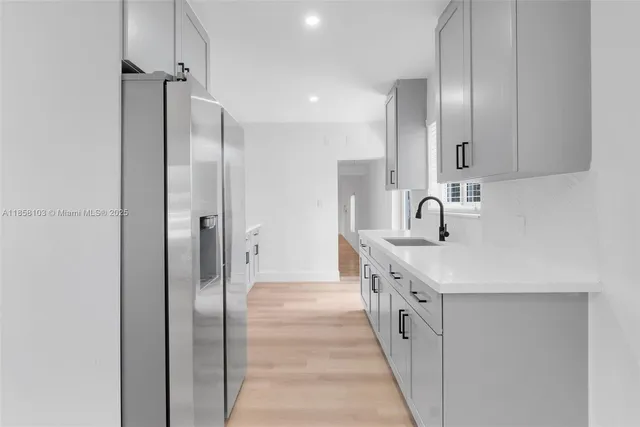 a kitchen with a sink and refrigerator