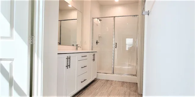 a view of a chair and table in the patio in front of house