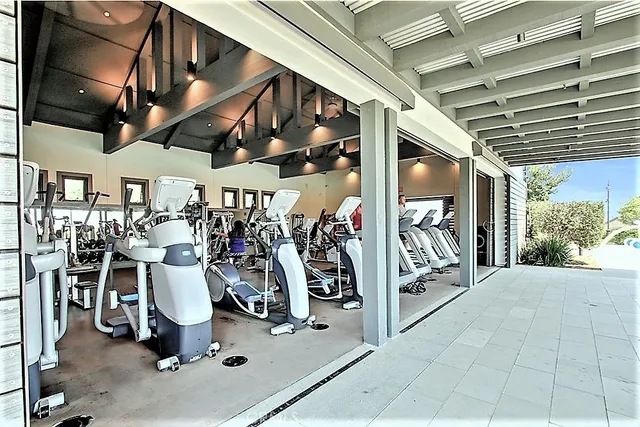 a living room with furniture wooden floor and a large window