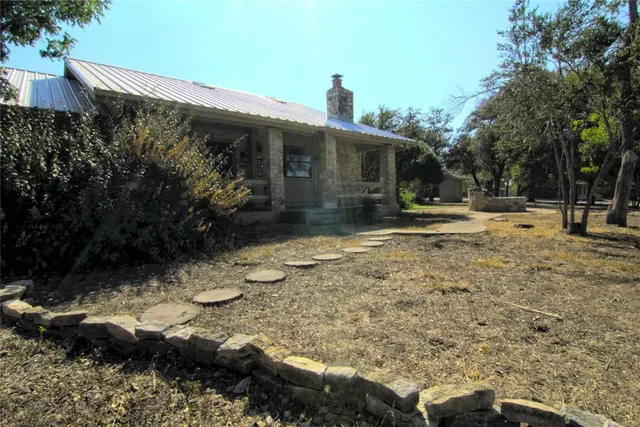 a backyard of a house with garden and patio
