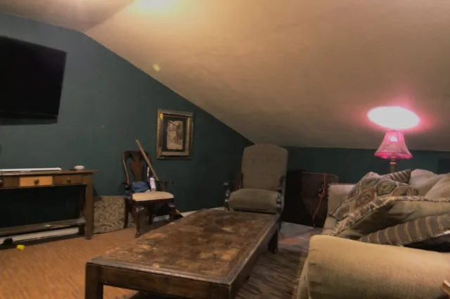 a living room with furniture and a lamp