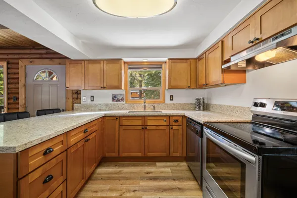a kitchen with a sink stove and cabinets