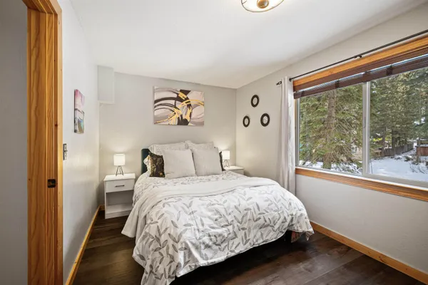 a bedroom with a bed and a painting on the wall