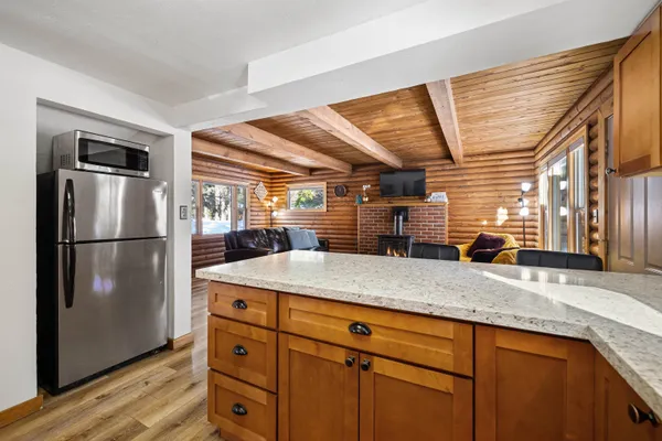 a kitchen with refrigerator and cabinets
