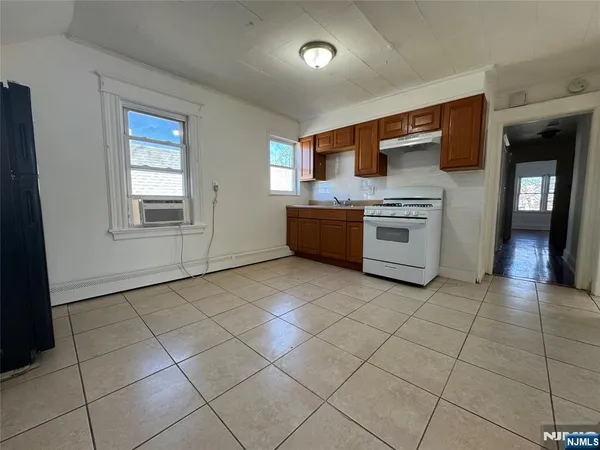 a large kitchen with a stove a sink dishwasher and a refrigerator