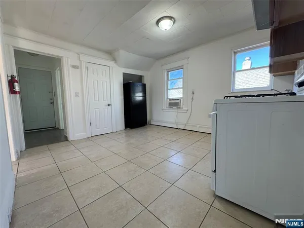 a view of a livingroom with an empty space and a window