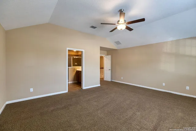 a view of an empty room with a ceiling fan