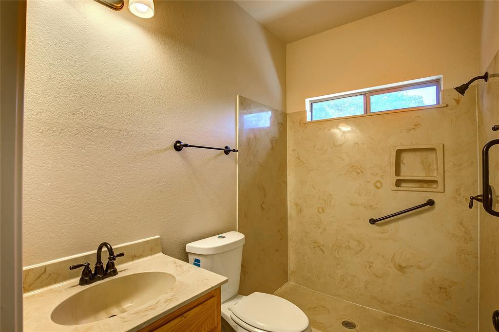2617 Kirby Road Rowlett, TX 75088 - Photo 18 of 39 Full bathroom featuring a walk in shower, vanity, and a textured wall