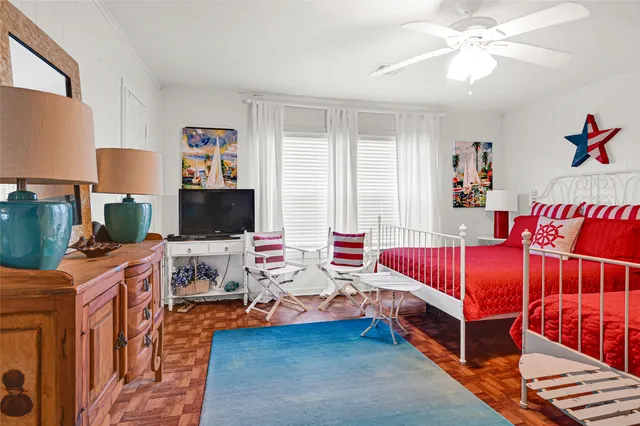 a bedroom with furniture and a flat screen tv