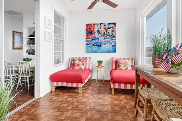 a living room with furniture a rug and a potted plant