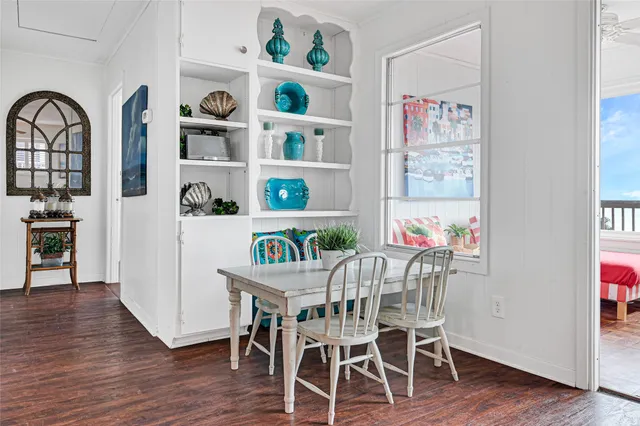 a dining room with furniture and wooden floor