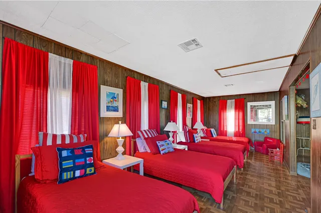 a bedroom with furniture and a large window