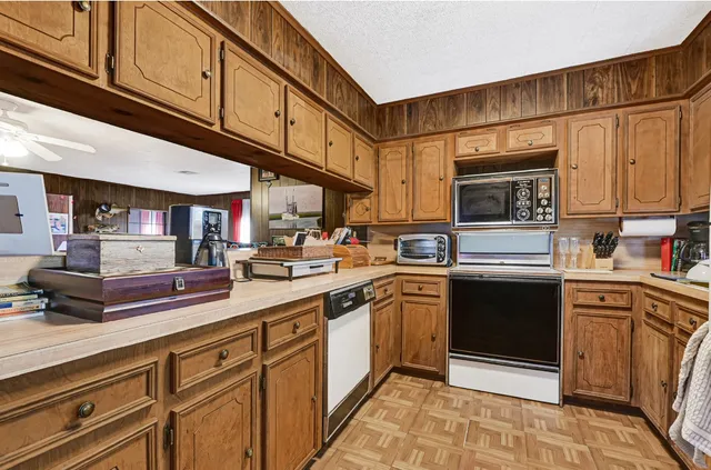 a kitchen with stainless steel appliances granite countertop a sink and cabinets