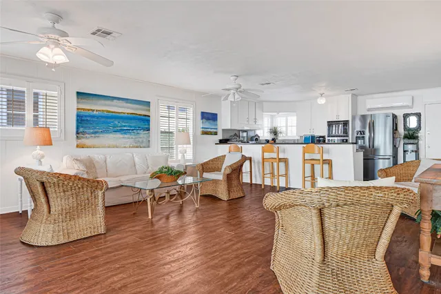 a living room with furniture and kitchen view