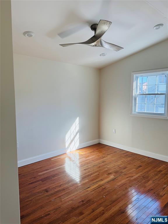14 Elm Street Paterson, NJ 07501 - Photo 6 of 11 a view of empty room with wooden floor and fan