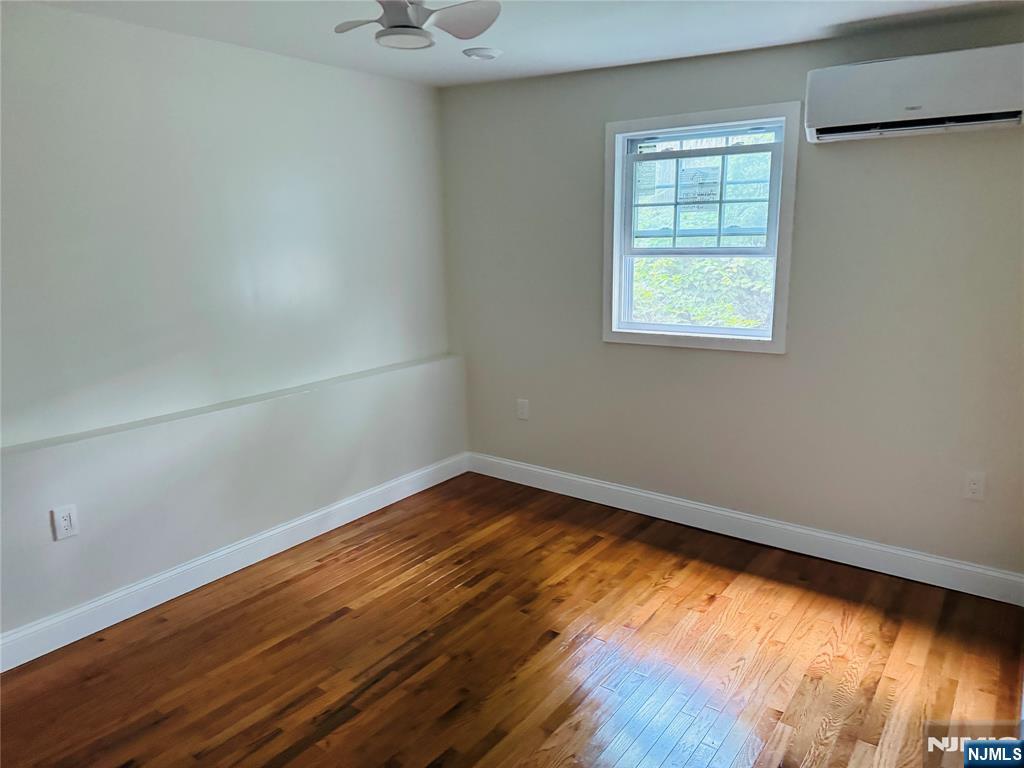 14 Elm Street Paterson, NJ 07501 - Photo 9 of 11 an empty room with wooden floor and windows