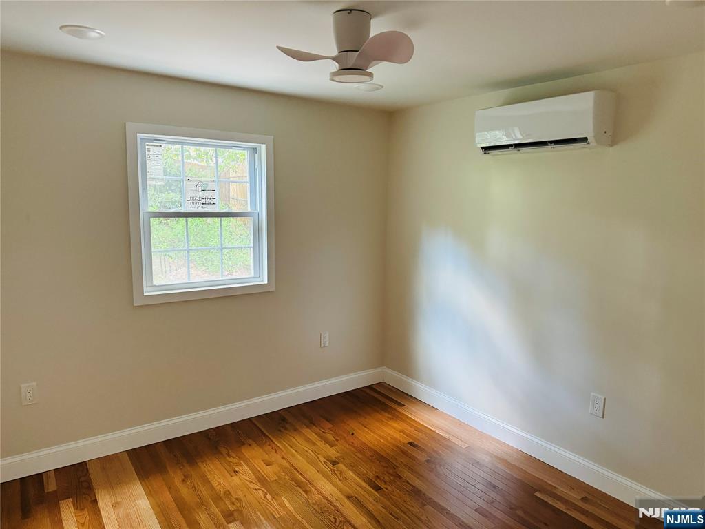14 Elm Street Paterson, NJ 07501 - Photo 10 of 11 a view of an empty room with wooden floor and a window