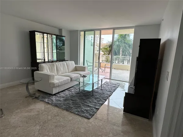 a living room with furniture and a floor to ceiling window