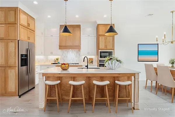a kitchen with a dining table chairs sink and cabinets