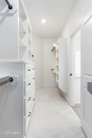 a bathroom with a double vanity sink toilet and a tub