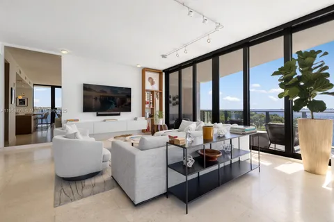 a living room with furniture tv and a large window