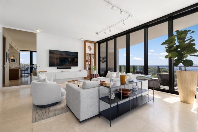 a living room with furniture tv and a large window