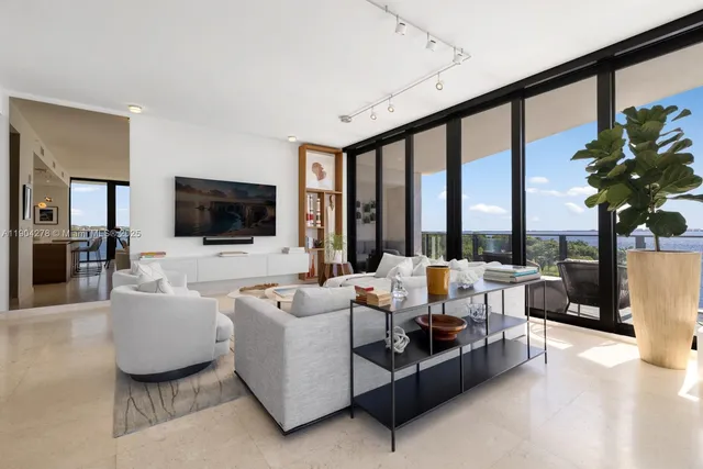 a living room with furniture tv and a large window