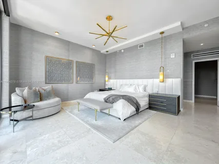 a bedroom with a bed couch and window