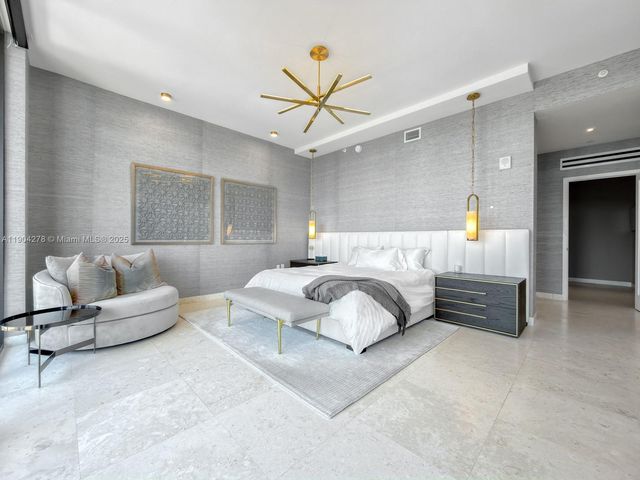 a bedroom with a bed couch and window