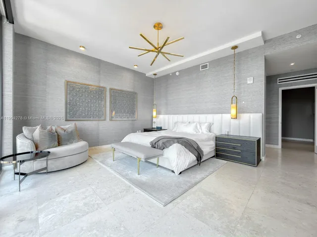 a bedroom with a bed couch and window