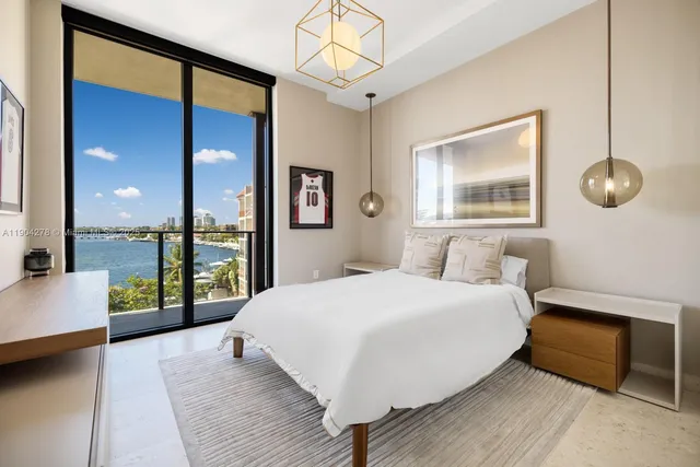 a bedroom with a large bed and a large window